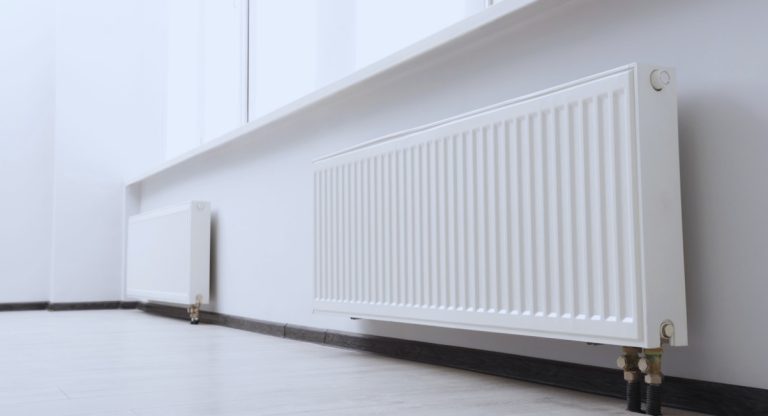Radiateurs blancs modernes installés le long d'un mur